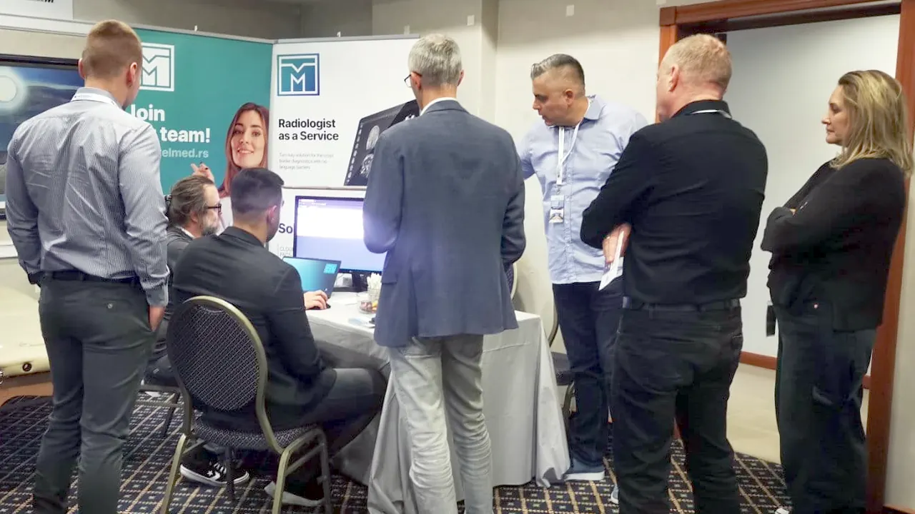 Radiologists gathered around a TelMed platform demonstration